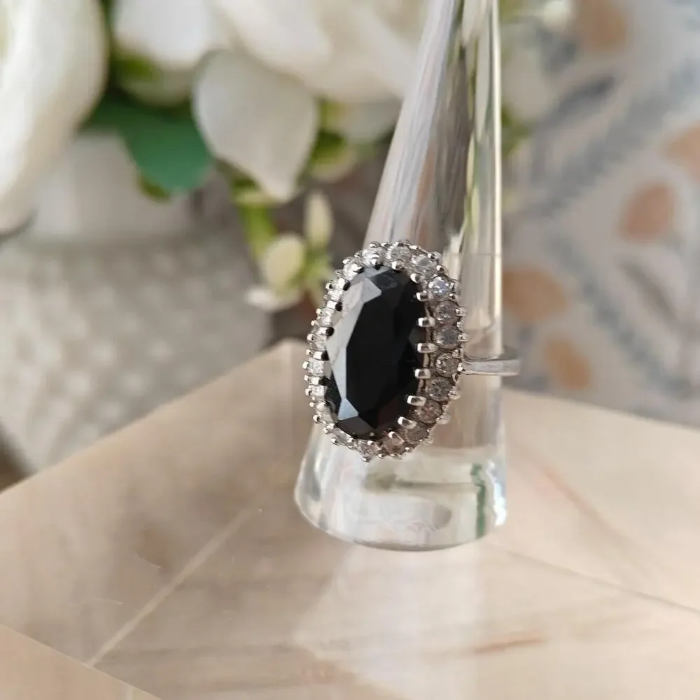Silver tone oval black glass halo ring with white rhinestones